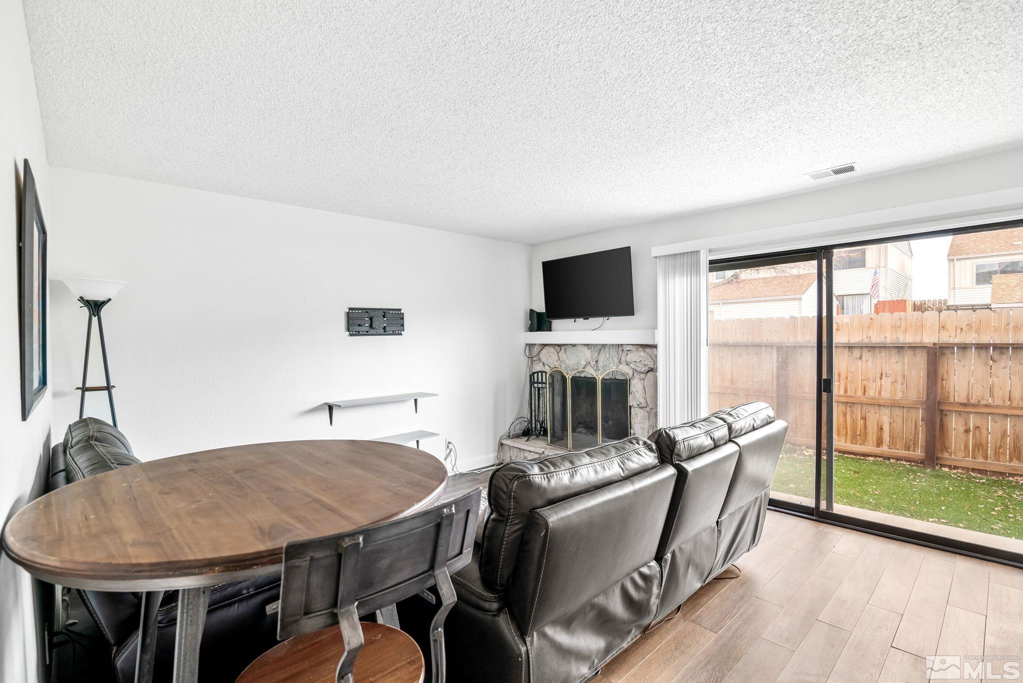 13968 Lear Boulevard Reno, NV 89506 - Photo 12 of 39 a living room with furniture a flat screen tv and a fireplace