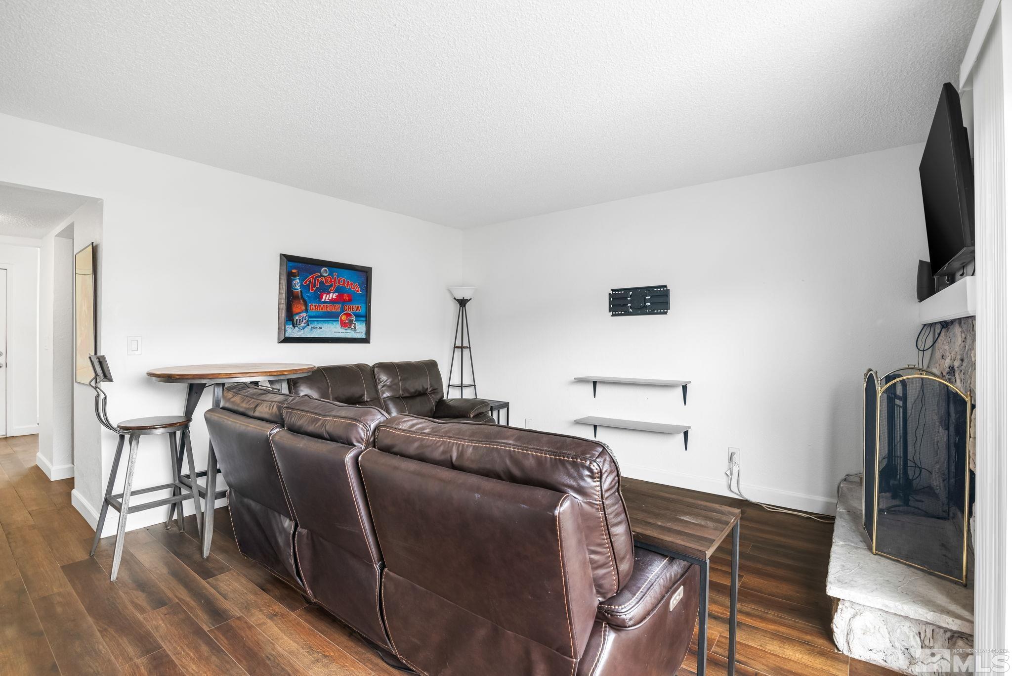 13968 Lear Boulevard Reno, NV 89506 - Photo 13 of 39 a living room with furniture and a flat screen tv