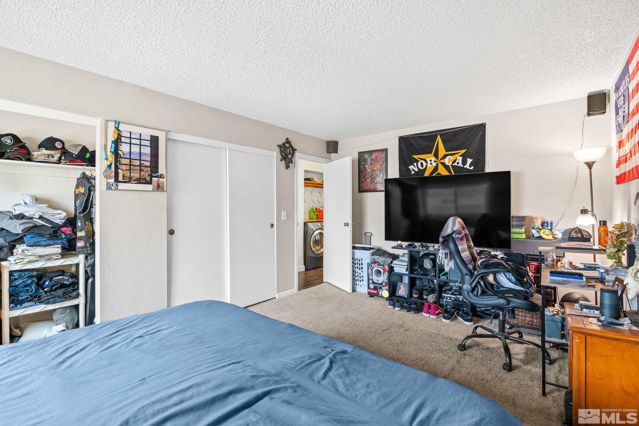 13968 Lear Boulevard Reno, NV 89506 - Photo 19 of 39 a bed room with a bed and a tv