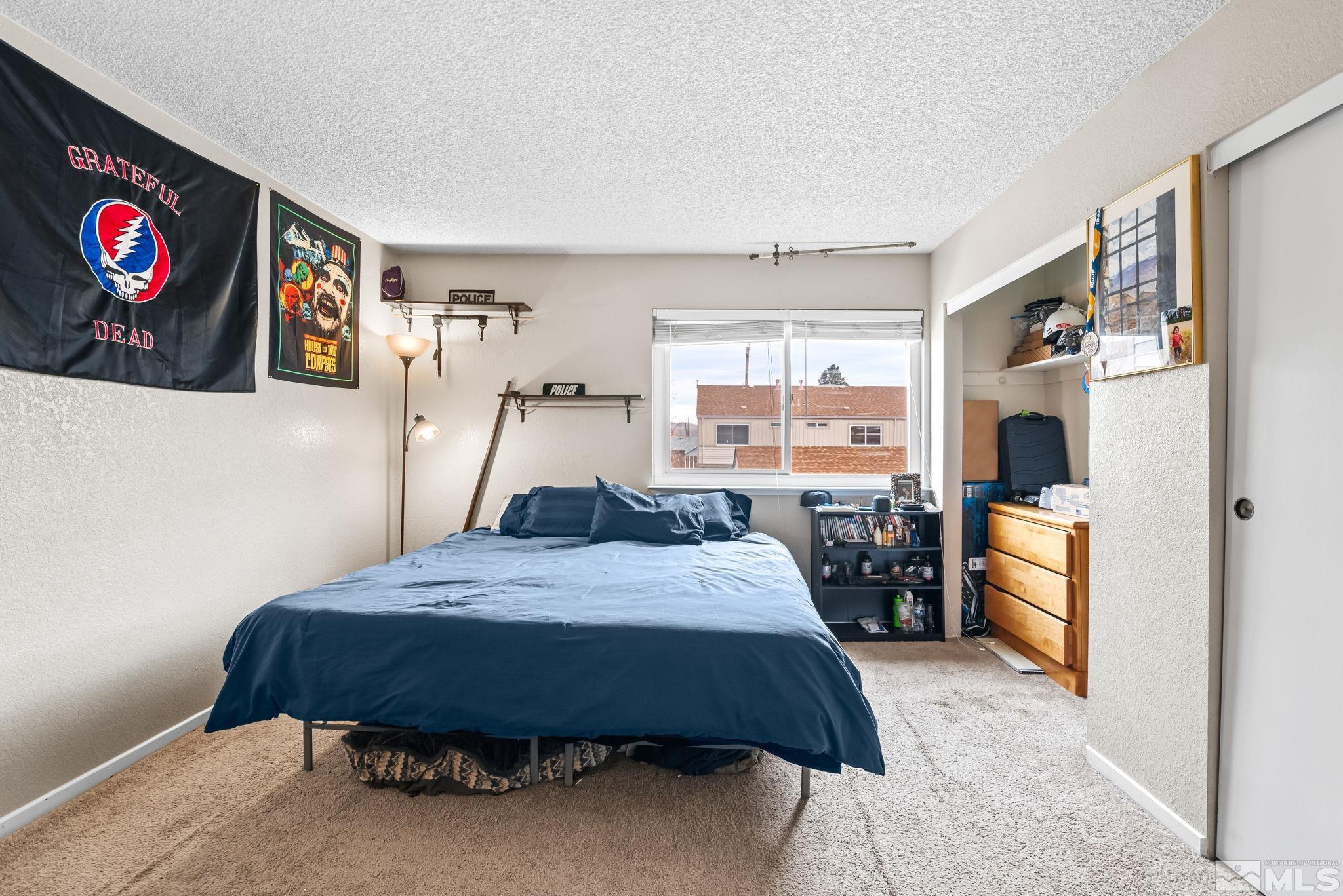 13968 Lear Boulevard Reno, NV 89506 - Photo 21 of 39 a bedroom with a bed and a refrigerator