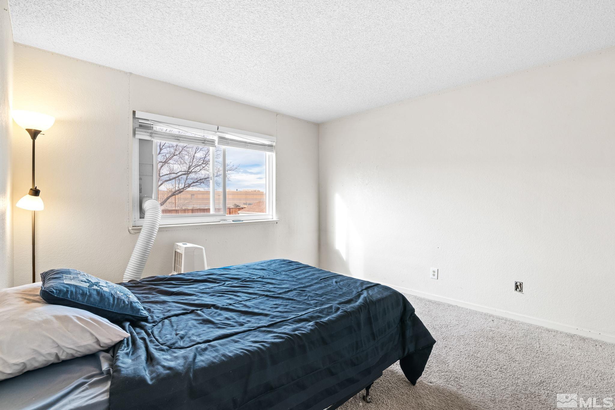 13968 Lear Boulevard Reno, NV 89506 - Photo 22 of 39 a bedroom with a bed and a window