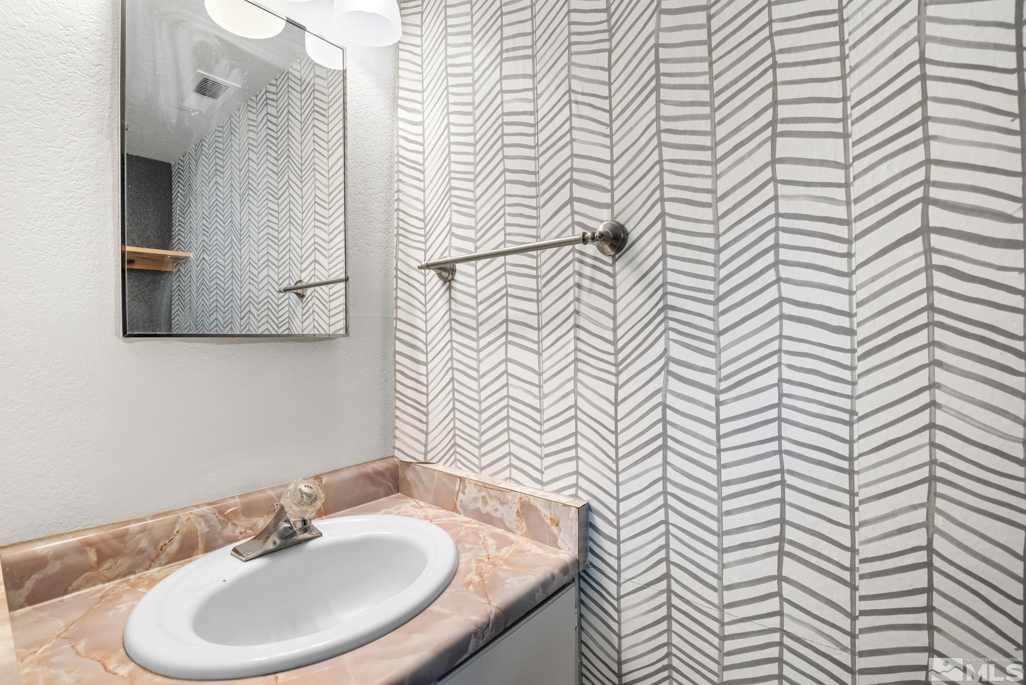 13968 Lear Boulevard Reno, NV 89506 - Photo 6 of 39 a bathroom with a sink and a mirror