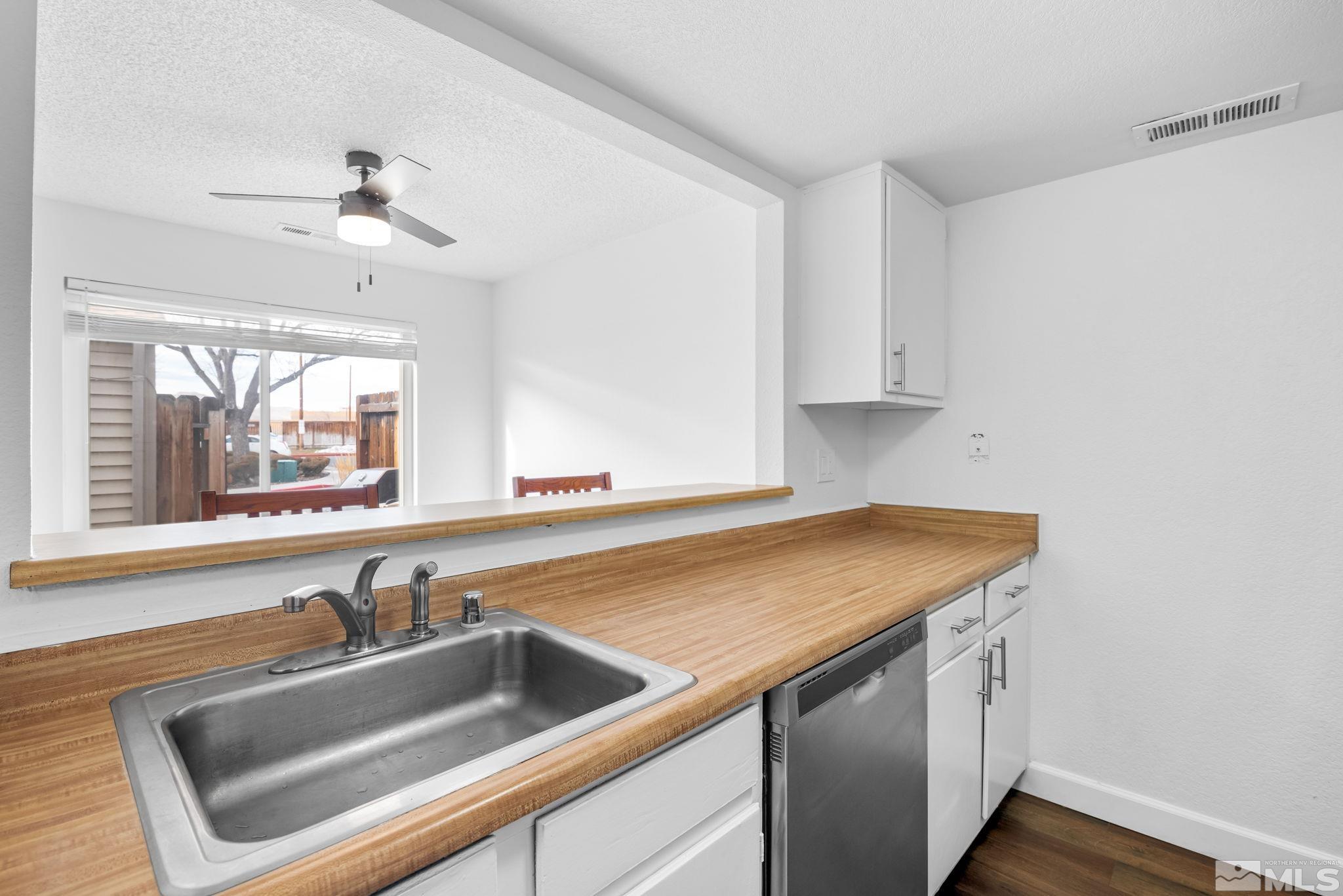 13968 Lear Boulevard Reno, NV 89506 - Photo 9 of 39 a view white cabinets and a sink