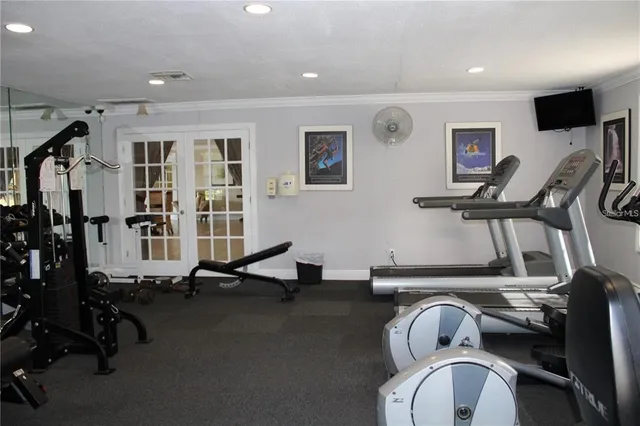 a room with gym equipment and a large window