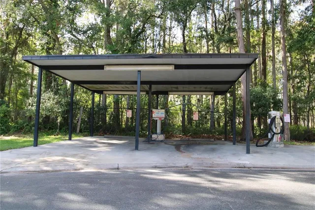 a backyard of a house with trees and outdoor seating
