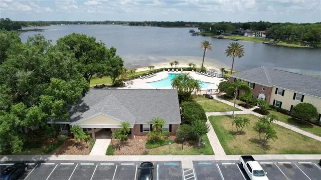 an aerial view of a house with a yard and lake view