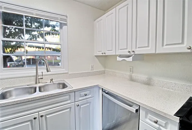 a kitchen with a sink and cabinets