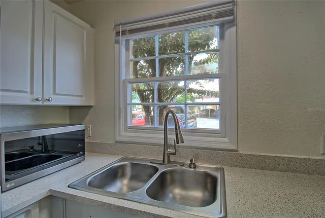 a sink and dishwasher next to a window