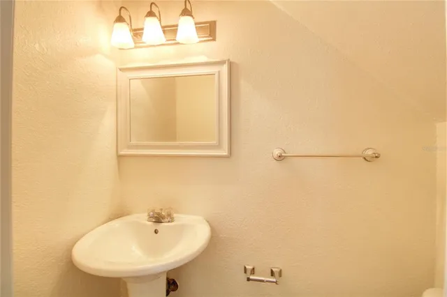 a bathroom with a sink a mirror and vanity