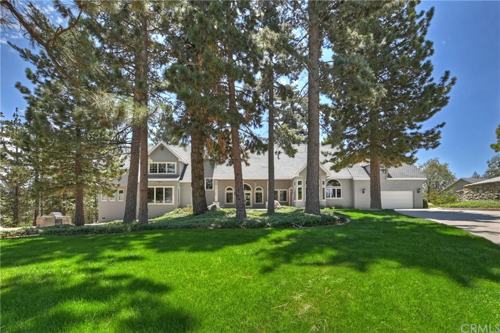 32516 Quail Ridge Running Springs, CA 92382 - Photo 1 of 1 a garden with trees in front of it
