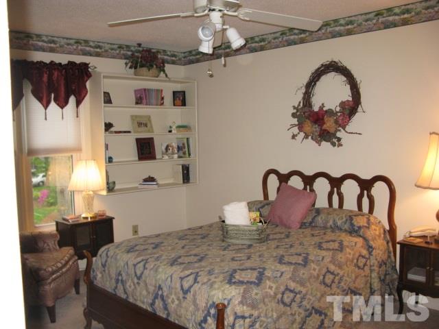 4201 Webster Court Raleigh, NC 27609 - Photo 13 of 25 a bedroom with a bed and a dresser