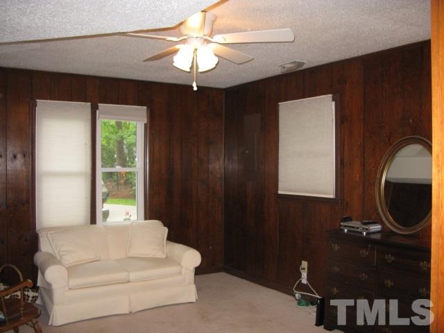 4201 Webster Court Raleigh, NC 27609 - Photo 18 of 25 a living room with furniture and a chandelier