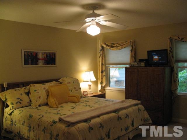 4201 Webster Court Raleigh, NC 27609 - Photo 7 of 25 a bedroom with a bed and a chandelier