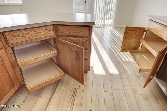 a view of a living room with entryway and wooden floor