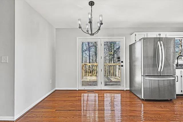 a view of an entryway with wooden floor