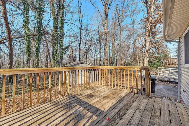 a view of balcony with wooden floor and fence