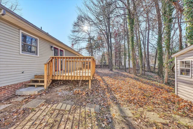 a backyard of a house with table and chairs
