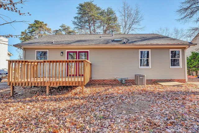 a backyard of a house with a garden and deck