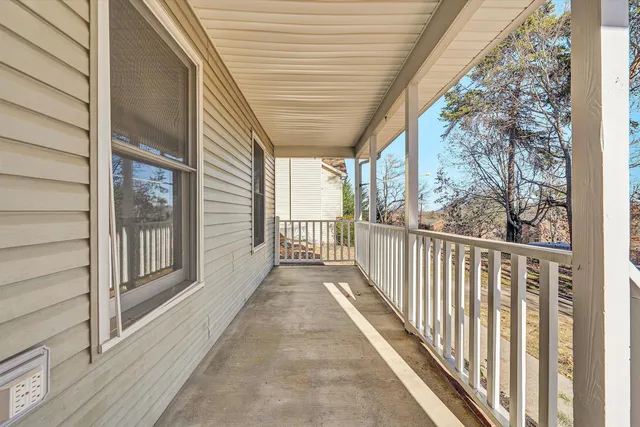 a view of a porch with wooden floor and stairs