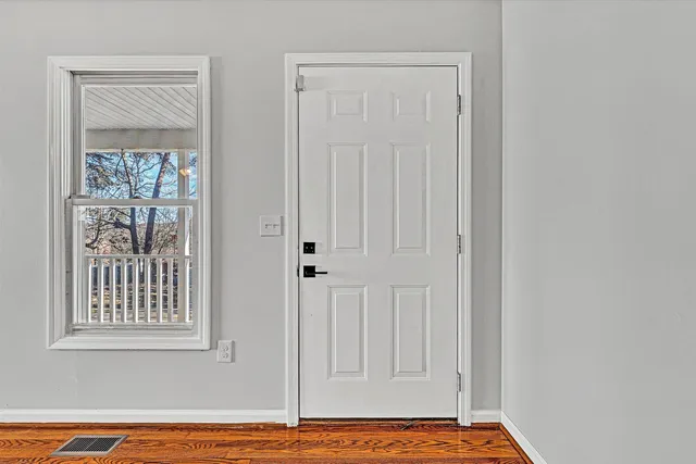 a view of a livingroom with wooden floor and a window