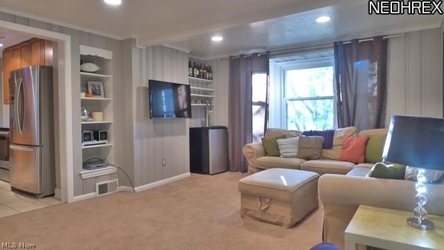 4869 Lander Road Chagrin Falls, OH 44022 - Photo 13 of 25 First floor Family Room with carpet and built-in shelving