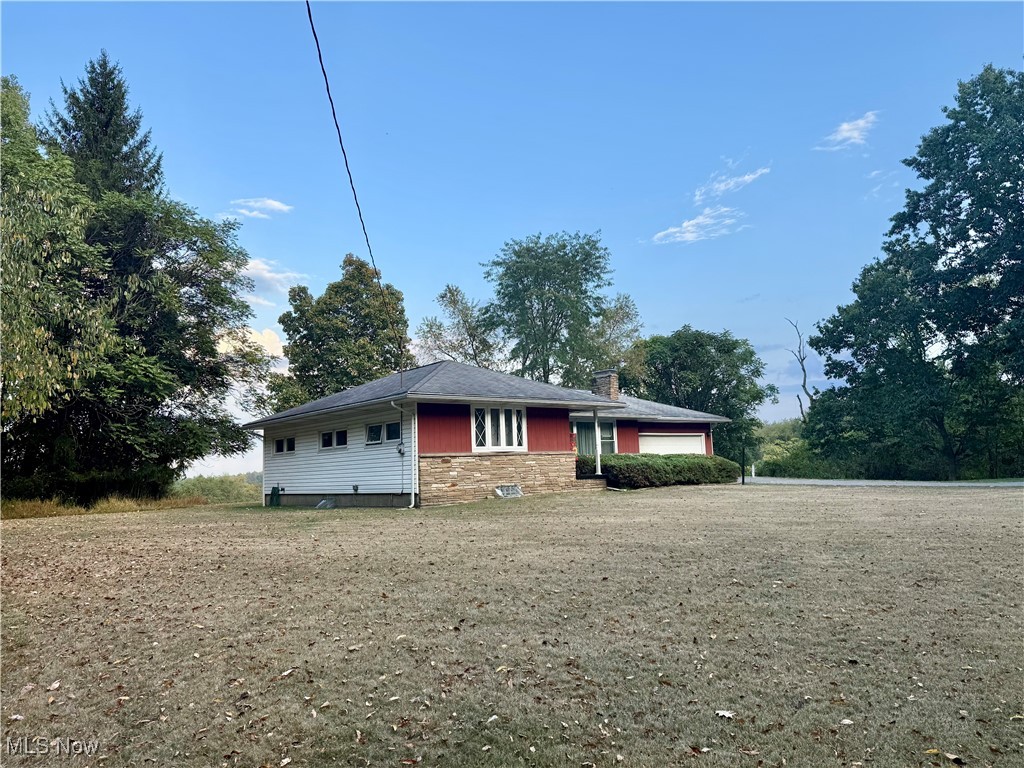 4878 Wylie Ridge Road New Cumberland, WV 26047 - Photo 18 of 20 Ranch-style house featuring a chimney, an attached garage, and stone siding