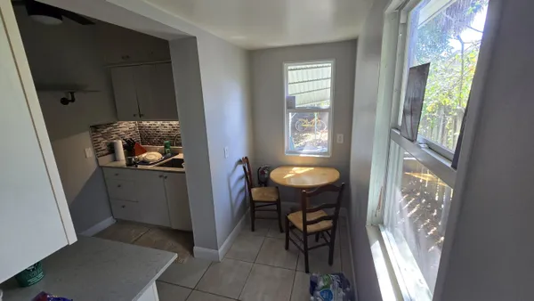 a kitchen with a refrigerator and a stove top oven
