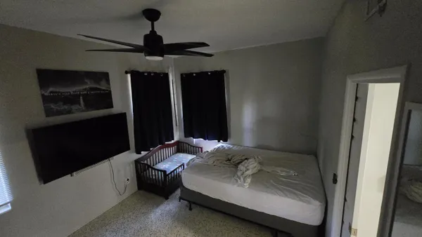 a bedroom with a bed and a mirror