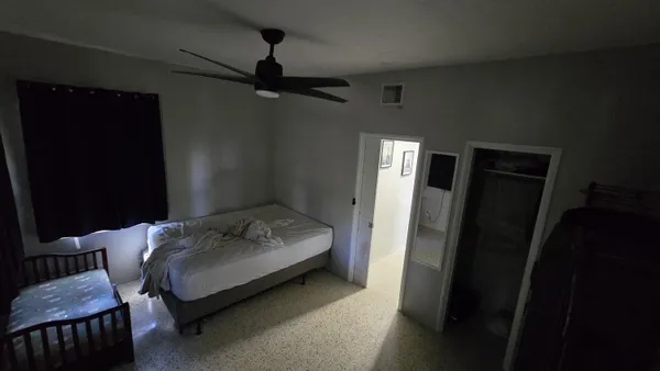a view of a hallway with closet and furniture