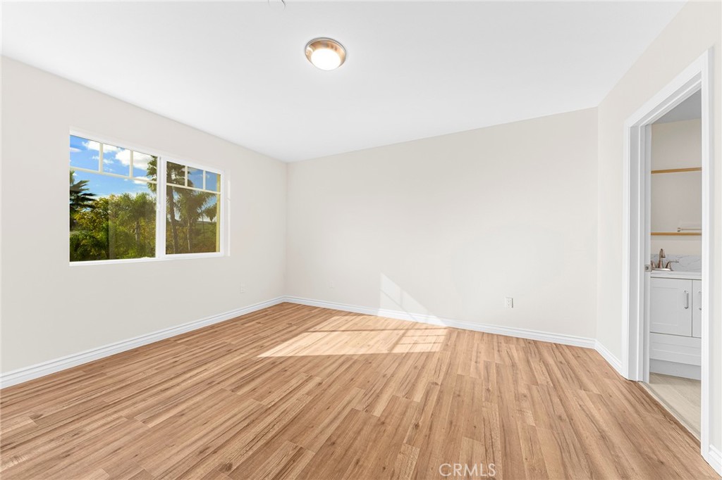 5639 Huntington Drive, Unit 1 Los Angeles, CA 90032 - Photo 11 of 25 an empty room with wooden floor and windows