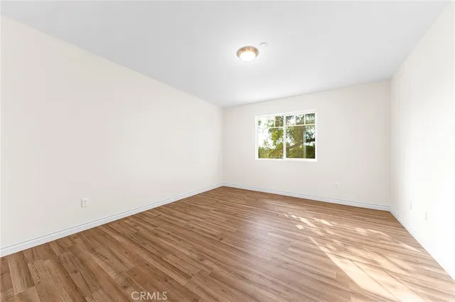a view of an empty room and wooden floor