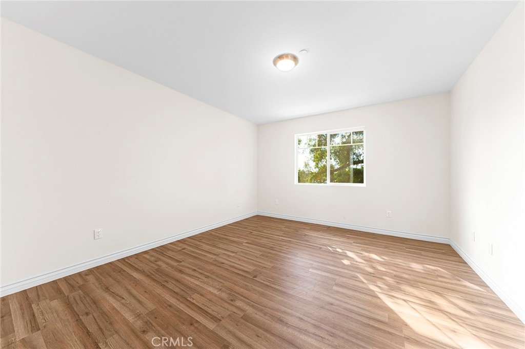 5639 Huntington Drive, Unit 1 Los Angeles, CA 90032 - Photo 15 of 25 an empty room with wooden floor and windows