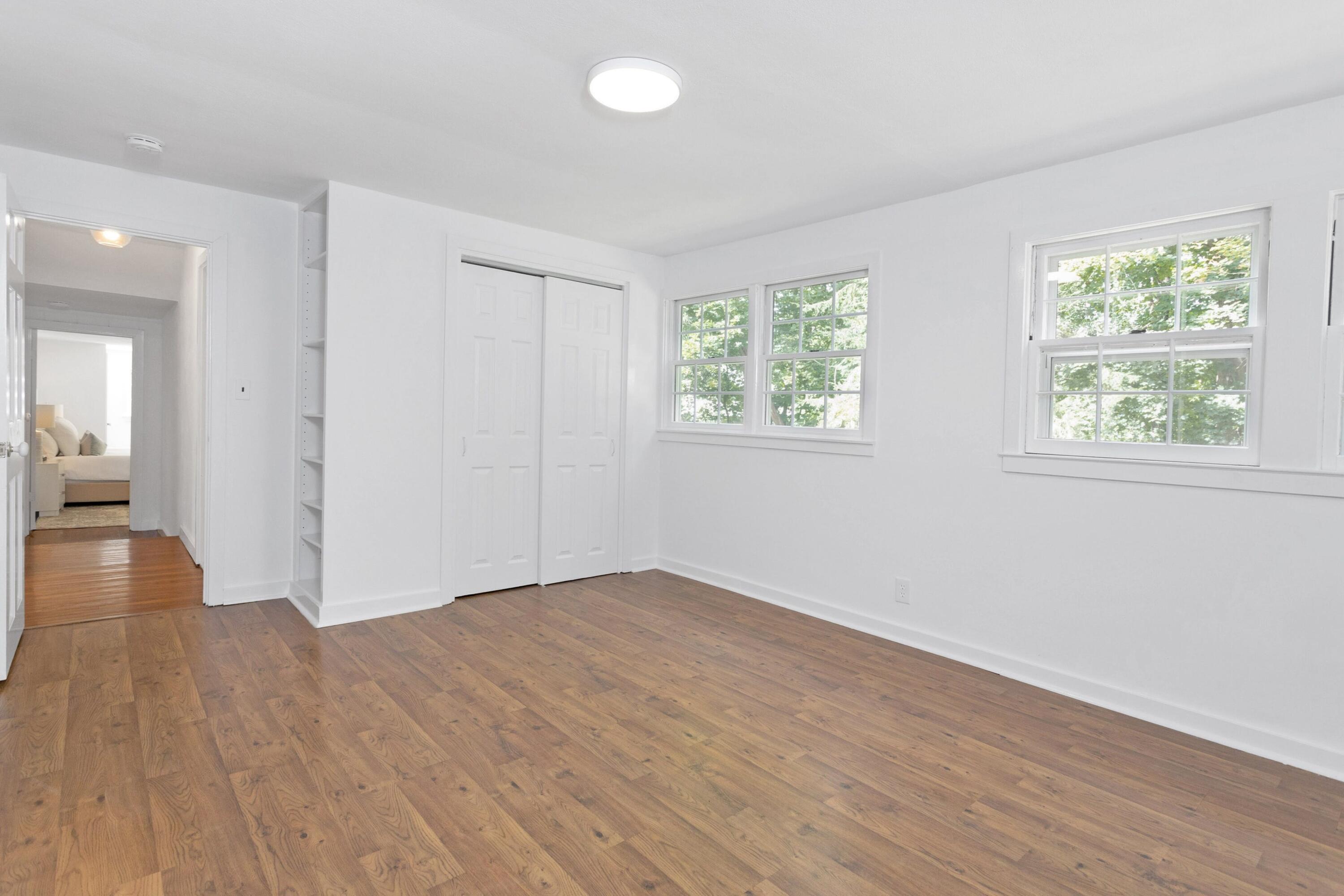 72 Dabney Road New Canaan, CT 06840 - Photo 17 of 23 an empty room with wooden floor and windows
