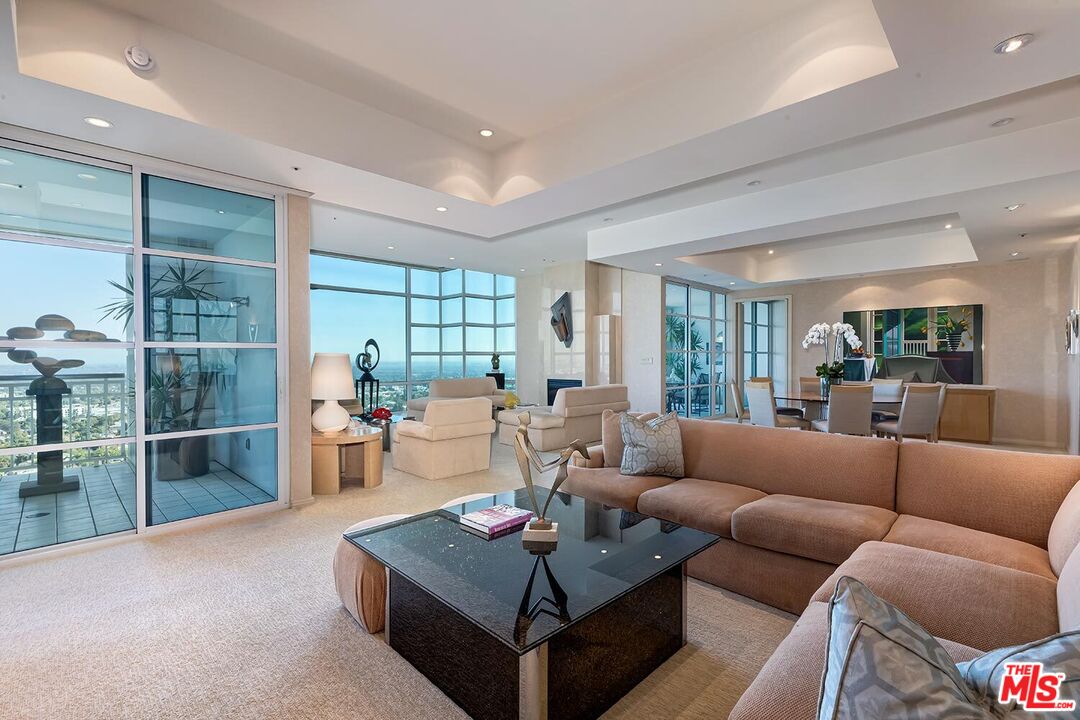 10380 Wilshire Boulevard, Unit 1703 Los Angeles, CA 90024 - Photo 11 of 34 a living room with furniture a lamp and a table
