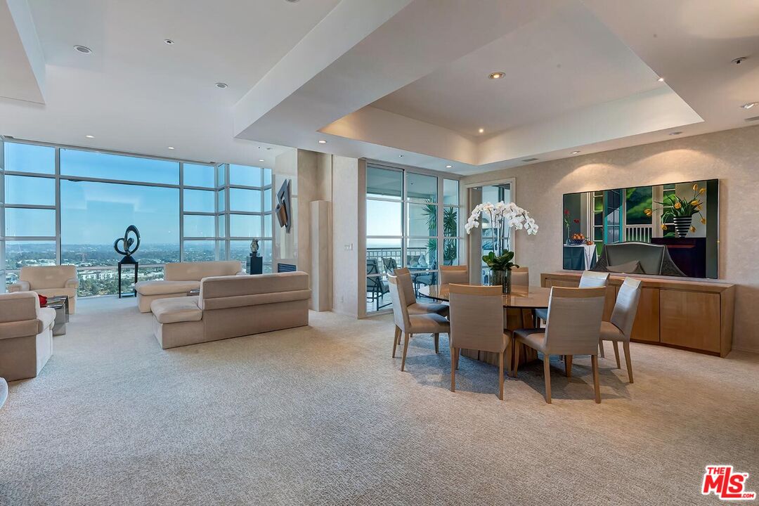 10380 Wilshire Boulevard, Unit 1703 Los Angeles, CA 90024 - Photo 12 of 34 a dining room with furniture and a potted plant