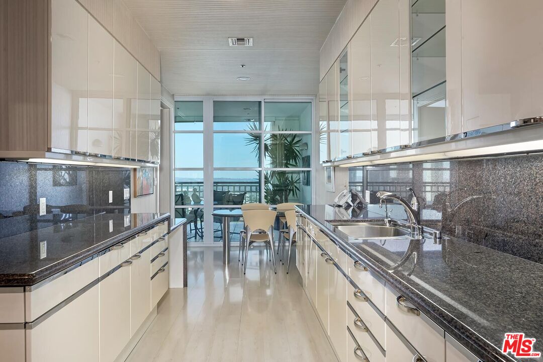 10380 Wilshire Boulevard, Unit 1703 Los Angeles, CA 90024 - Photo 17 of 34 a kitchen with stainless steel appliances a sink a stove and cabinets