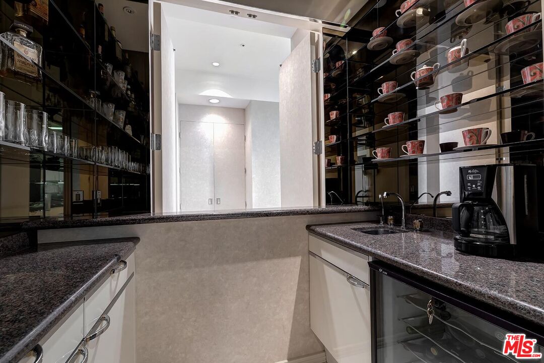 10380 Wilshire Boulevard, Unit 1703 Los Angeles, CA 90024 - Photo 20 of 34 a kitchen with a sink and cabinets