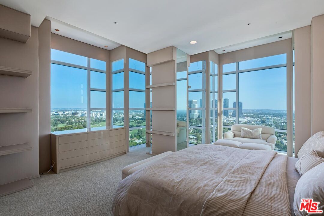 10380 Wilshire Boulevard, Unit 1703 Los Angeles, CA 90024 - Photo 21 of 34 a bedroom with a large bed and windows