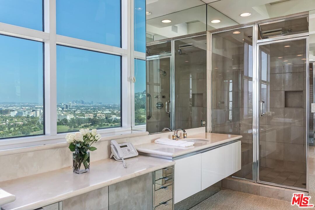 10380 Wilshire Boulevard, Unit 1703 Los Angeles, CA 90024 - Photo 25 of 34 a bathroom with a double vanity sink and mirror