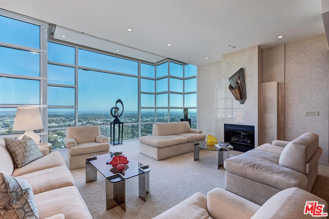 10380 Wilshire Boulevard, Unit 1703 Los Angeles, CA 90024 - Photo 5 of 34 a living room with furniture fireplace and a fireplace