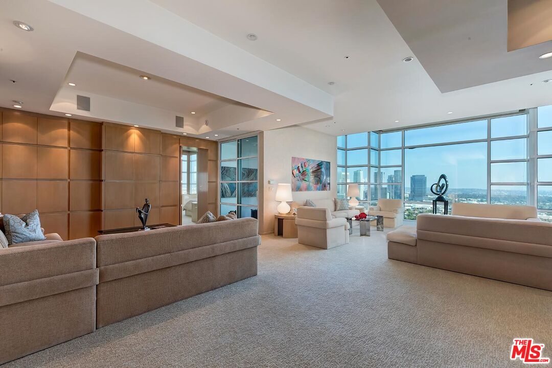 10380 Wilshire Boulevard, Unit 1703 Los Angeles, CA 90024 - Photo 10 of 34 a living room with furniture and a table