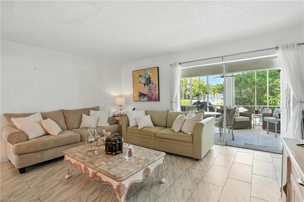 14 Watercolor Way, Unit 14 Naples, FL 34113 - Photo 1 of 37 a living room with furniture and a large window