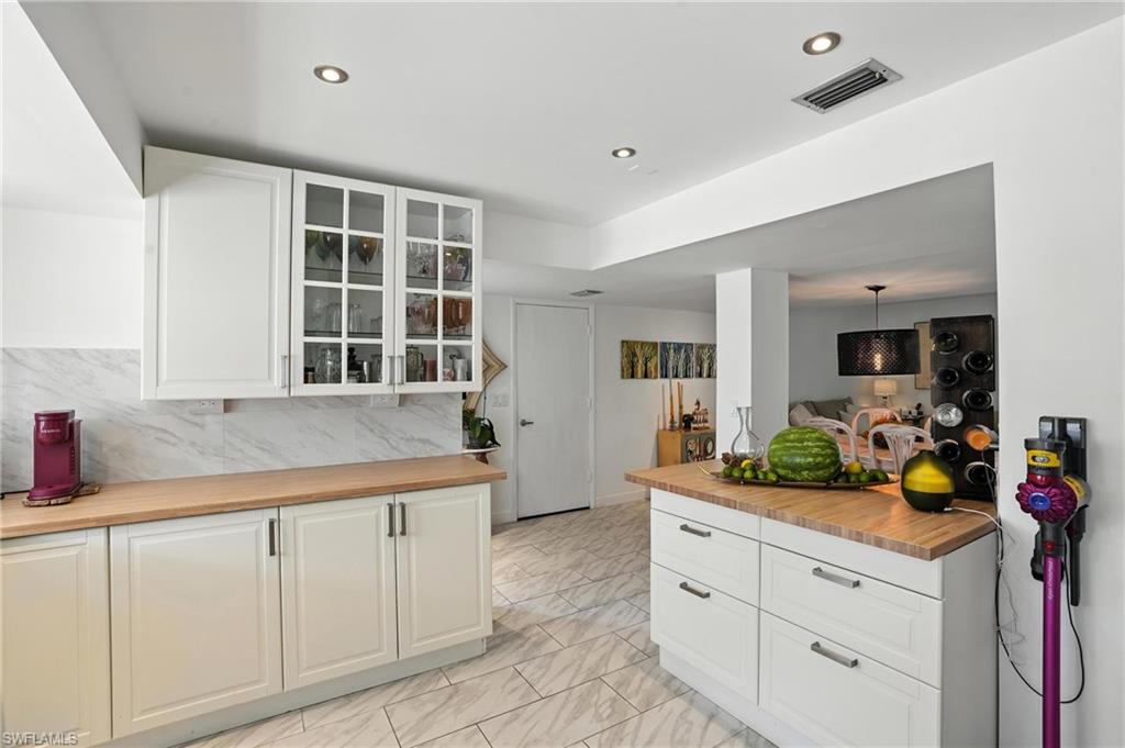 14 Watercolor Way, Unit 14 Naples, FL 34113 - Photo 11 of 37 a kitchen with white cabinets and sink