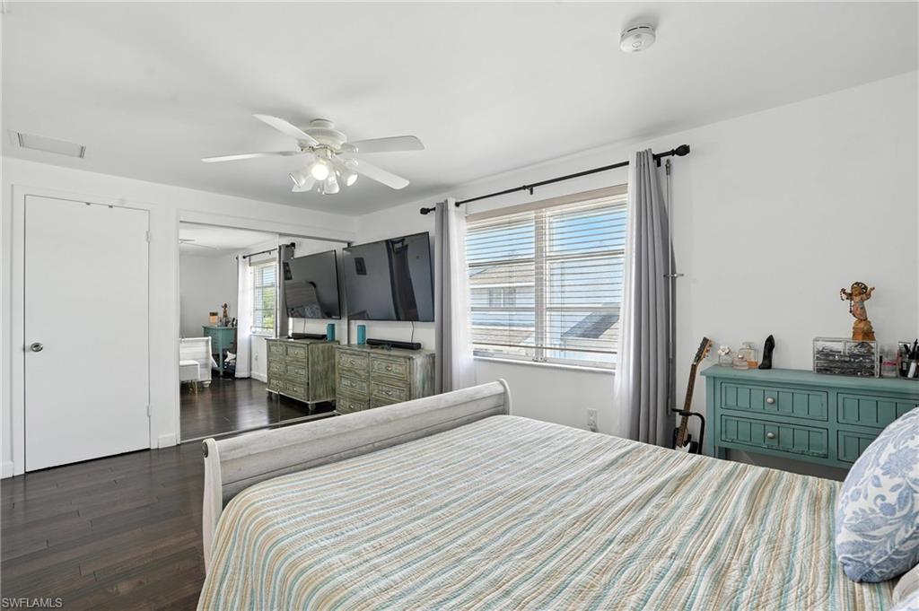 14 Watercolor Way, Unit 14 Naples, FL 34113 - Photo 14 of 37 a bedroom with a bed and a dresser
