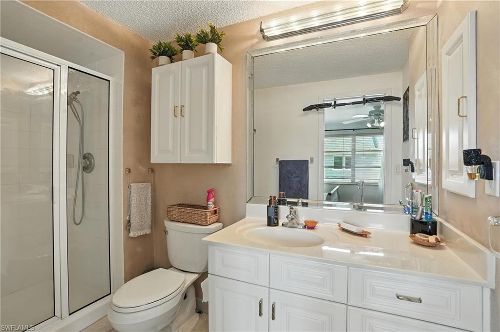 14 Watercolor Way, Unit 14 Naples, FL 34113 - Photo 16 of 37 a bathroom with a sink a toilet and shower