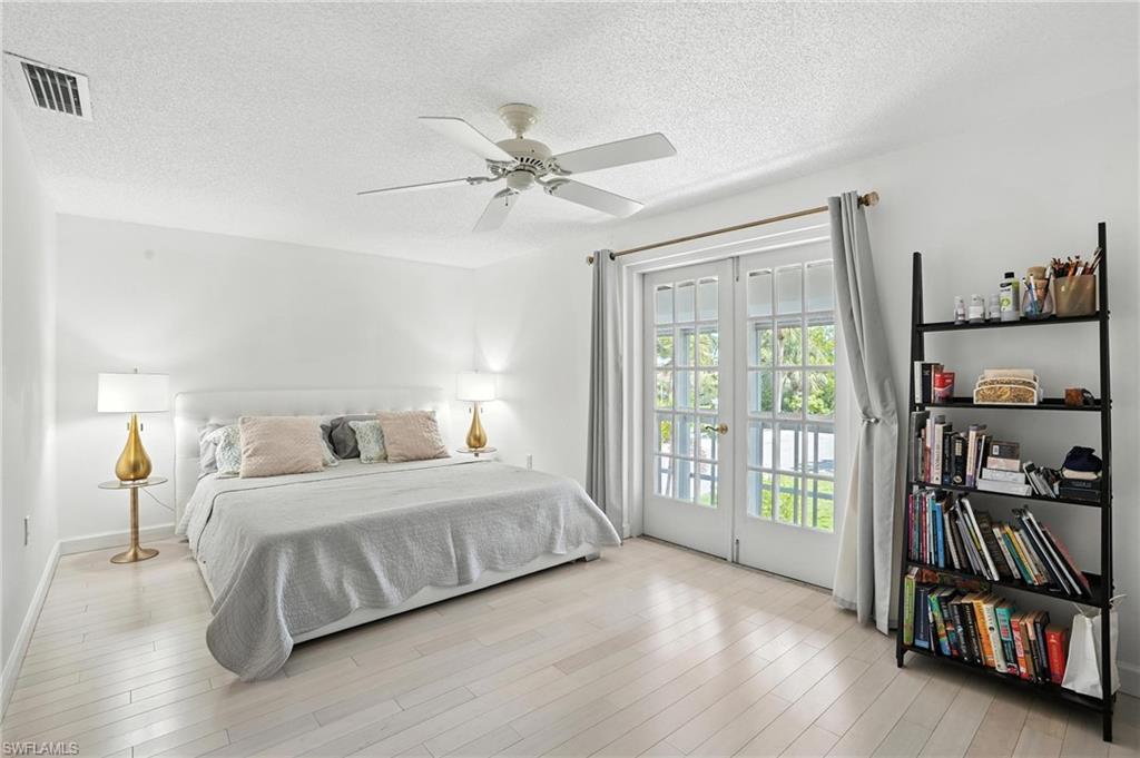 14 Watercolor Way, Unit 14 Naples, FL 34113 - Photo 17 of 37 a bedroom with a bed furniture and a window