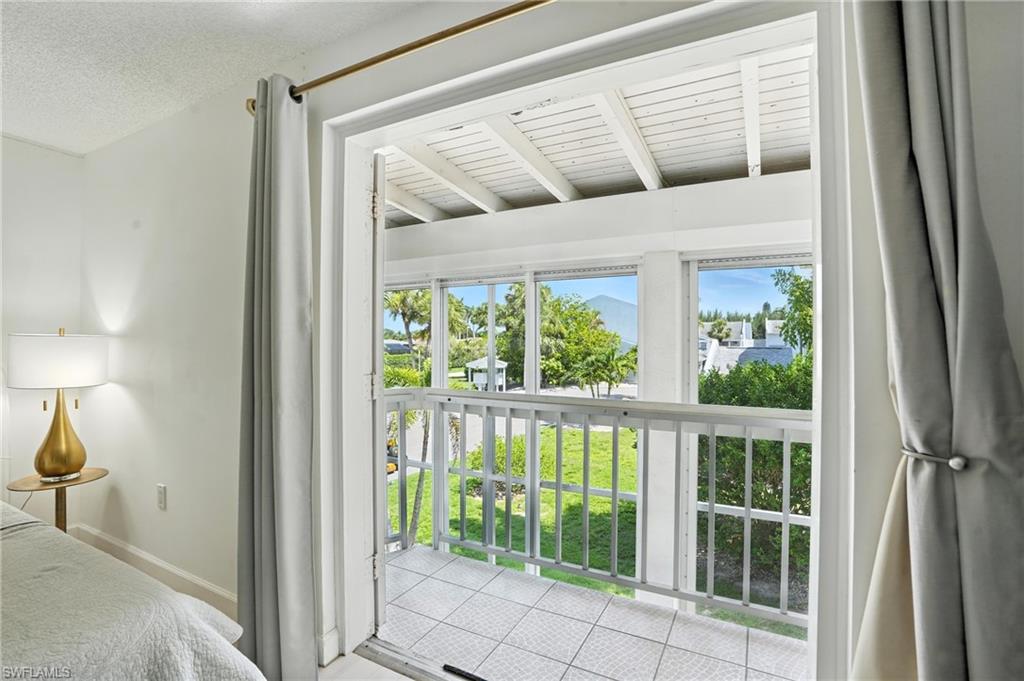 14 Watercolor Way, Unit 14 Naples, FL 34113 - Photo 18 of 37 a very nice looking room with a large window and a glass door shower