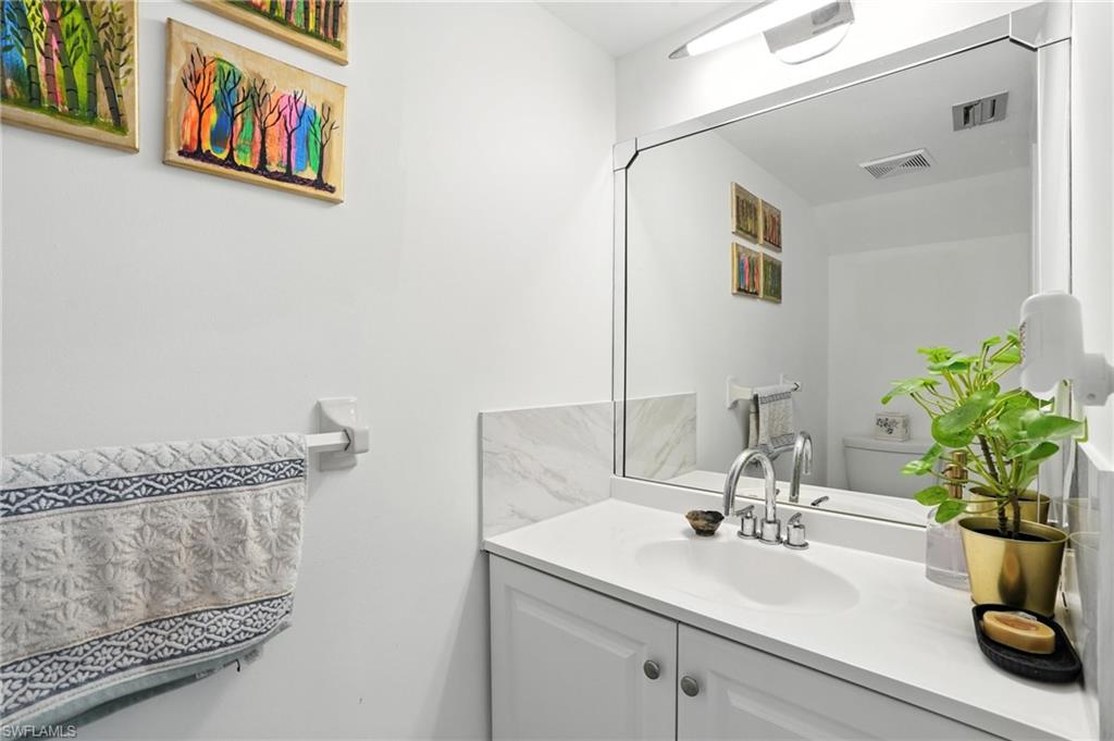 14 Watercolor Way, Unit 14 Naples, FL 34113 - Photo 23 of 37 a bathroom with a sink and a mirror