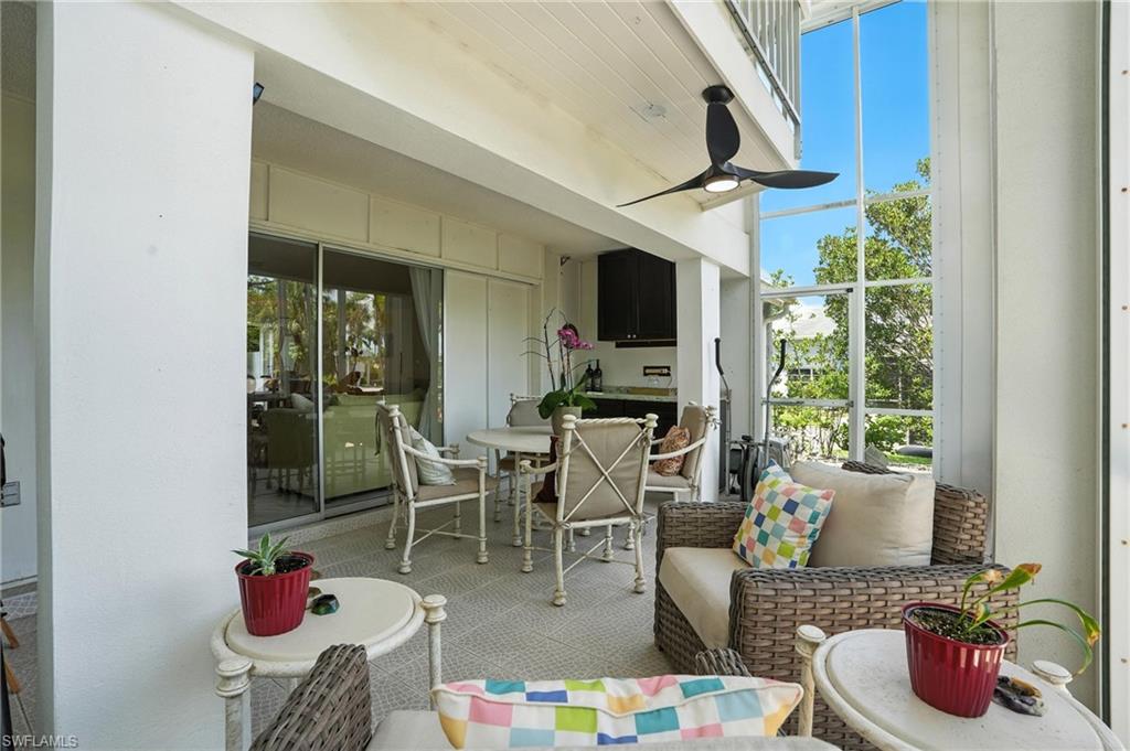 14 Watercolor Way, Unit 14 Naples, FL 34113 - Photo 27 of 37 a dining room with furniture floor to ceiling window and potted plants