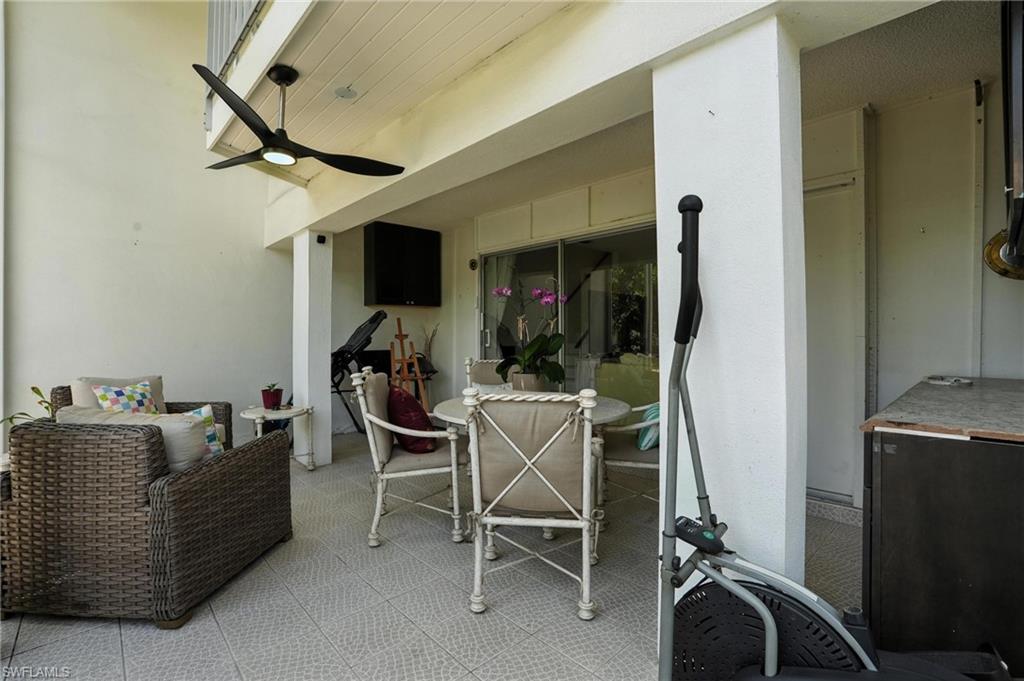 14 Watercolor Way, Unit 14 Naples, FL 34113 - Photo 28 of 37 a room with furniture a flat screen tv and gym equipment